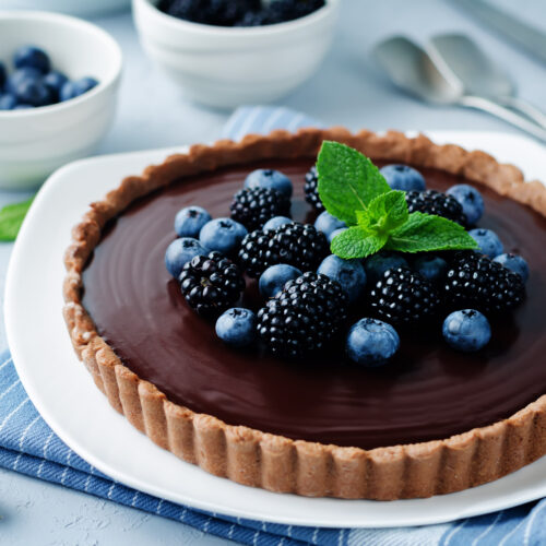 Chocolate tart with blackberries and blueberries.