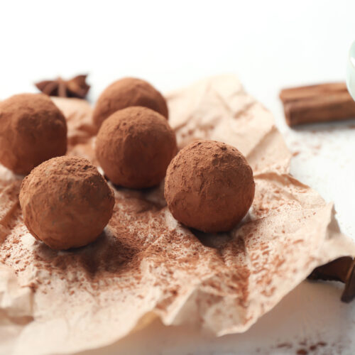 Tasty chocolate truffles on white table, closeup