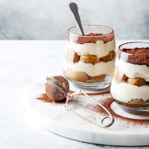 Traditional Italian dessert tiramisu in a glass.